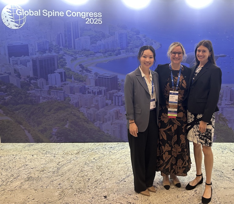 Olinger with resident and medical student at conference