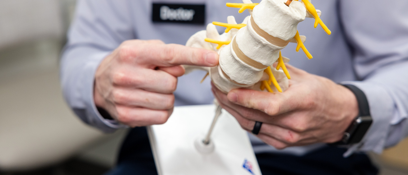 Joshua Eisenberg, MD, with simulated spine patient in the orthopedics clinic at UI Health Care Medical Center North Liberty on Tuesday, April 29, 2025. 
