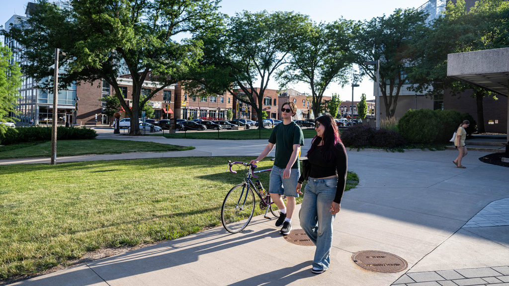 Two students walking together on campus.